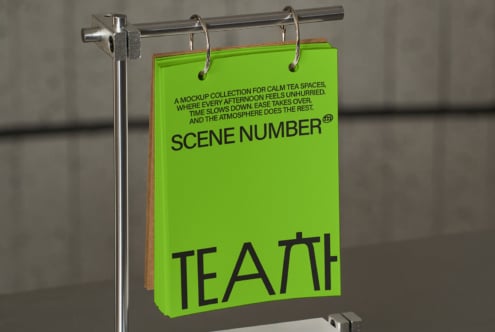 Lime green cardstock hanging on rod with black text visible from side angle