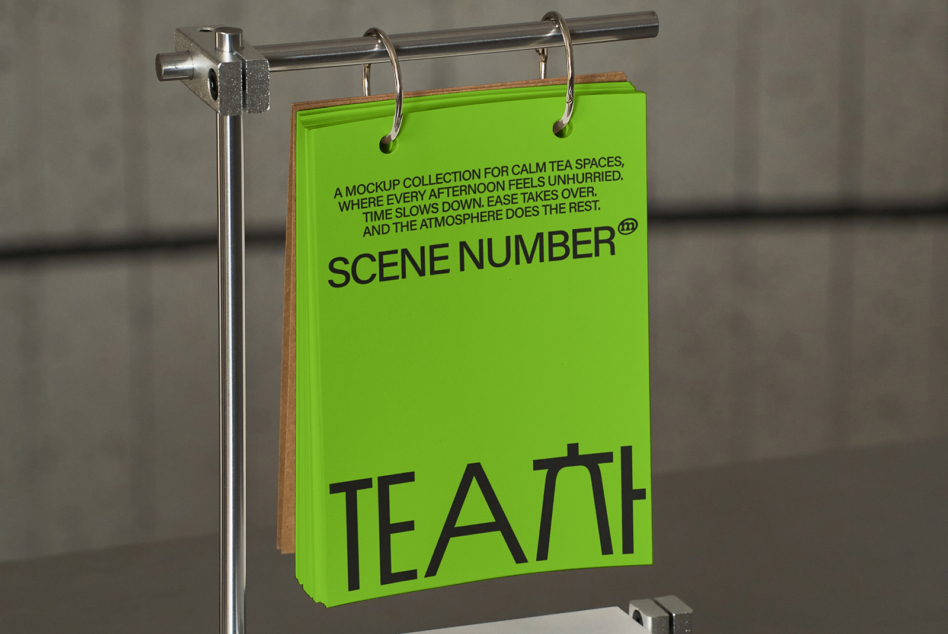 Lime green cardstock hanging on rod with black text visible from side angle