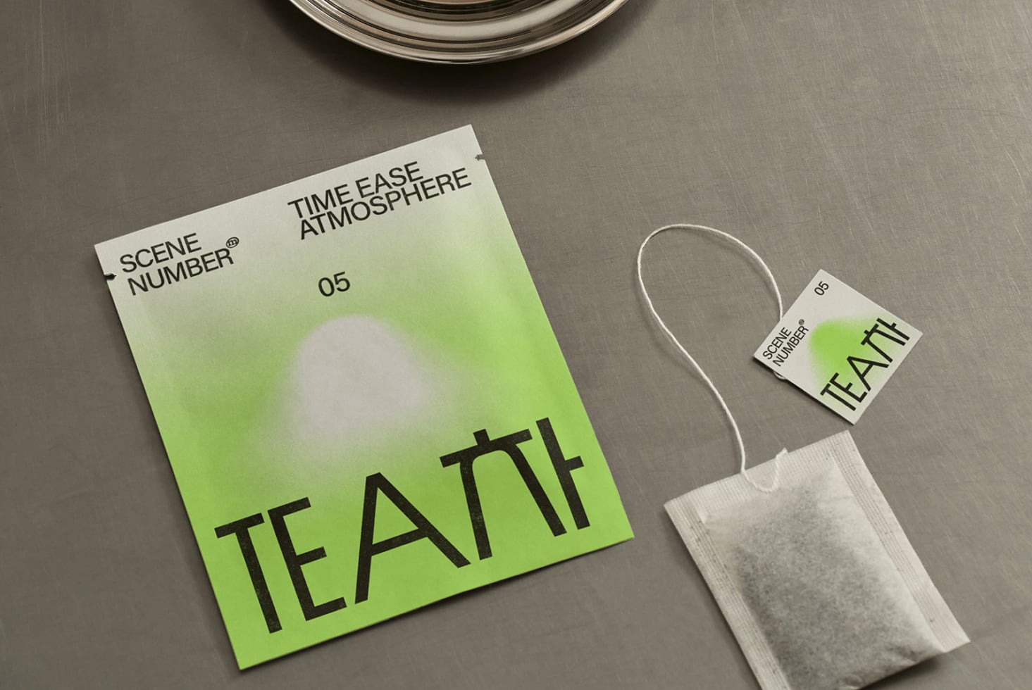 Bright lime tea branding set with package, tag, loose leaf overhead composition