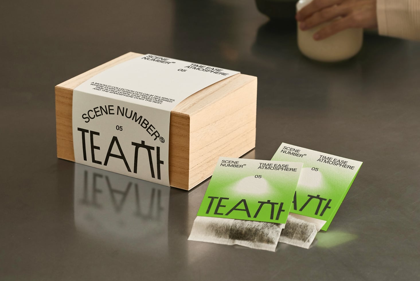 Tea packaging mockup includes wood box, metal canister, tea bag wrappers bundle