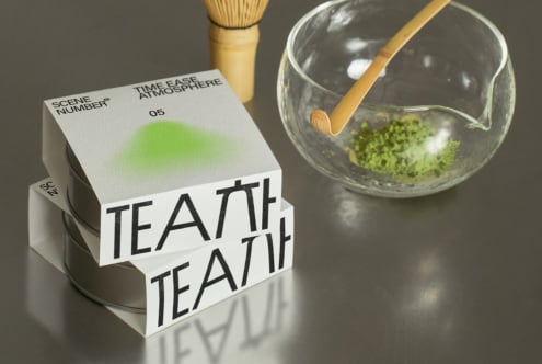 White packaging box with gradient green showing matcha preparation tools nearby