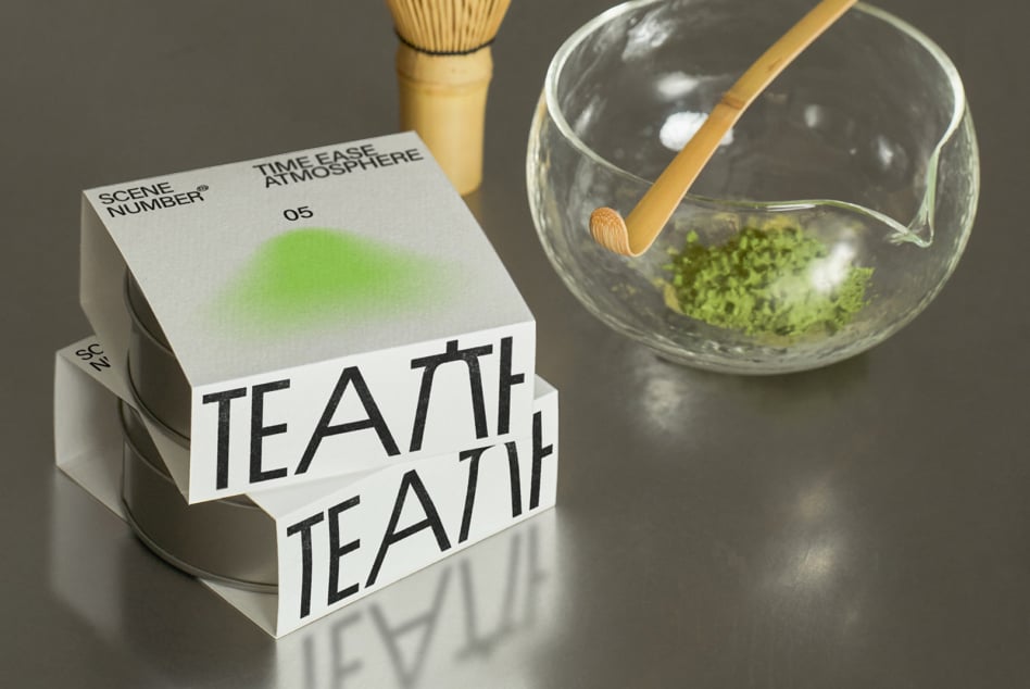 White packaging box with gradient green showing matcha preparation tools nearby