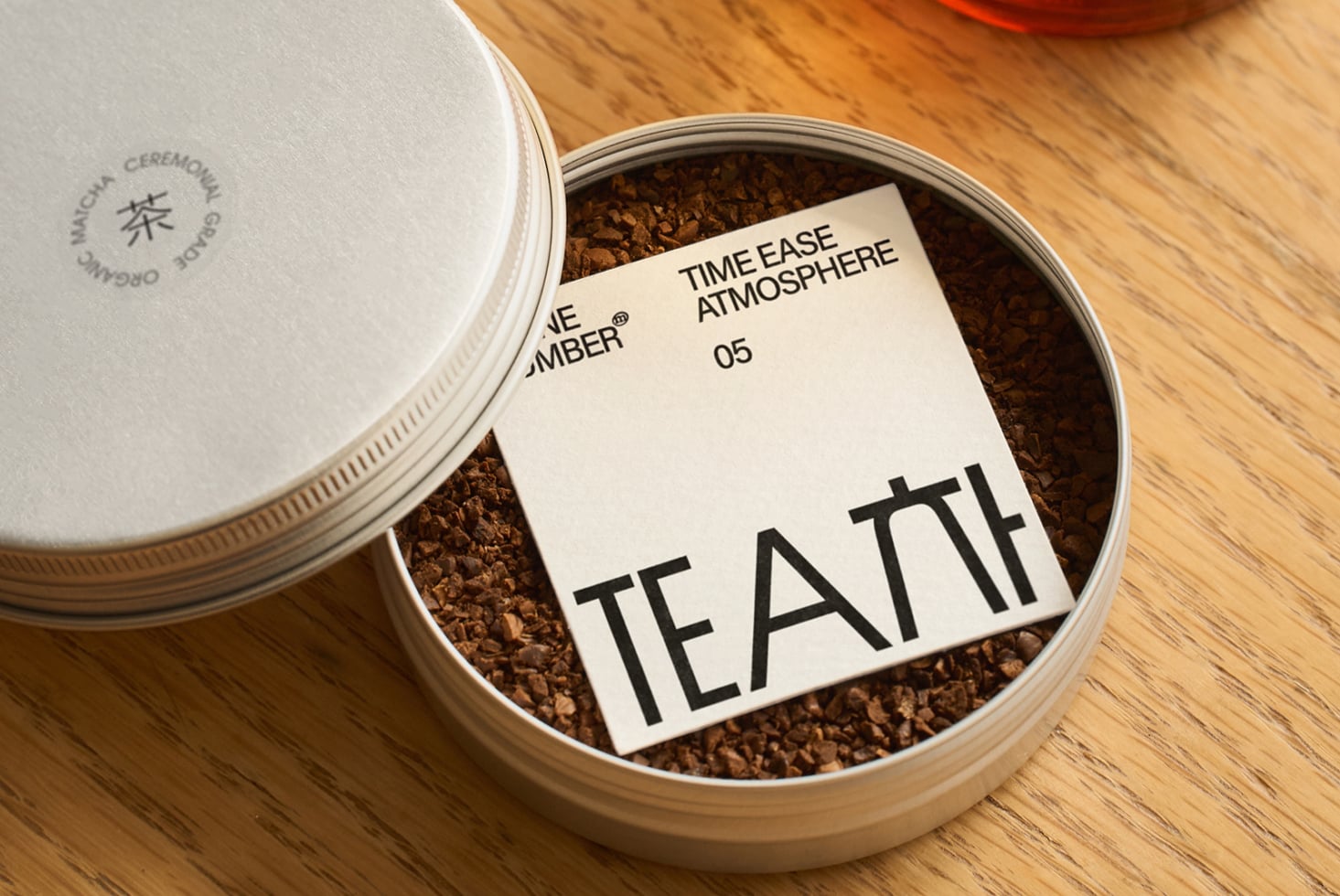 Open tea tin showing loose cocoa powder with product label inside