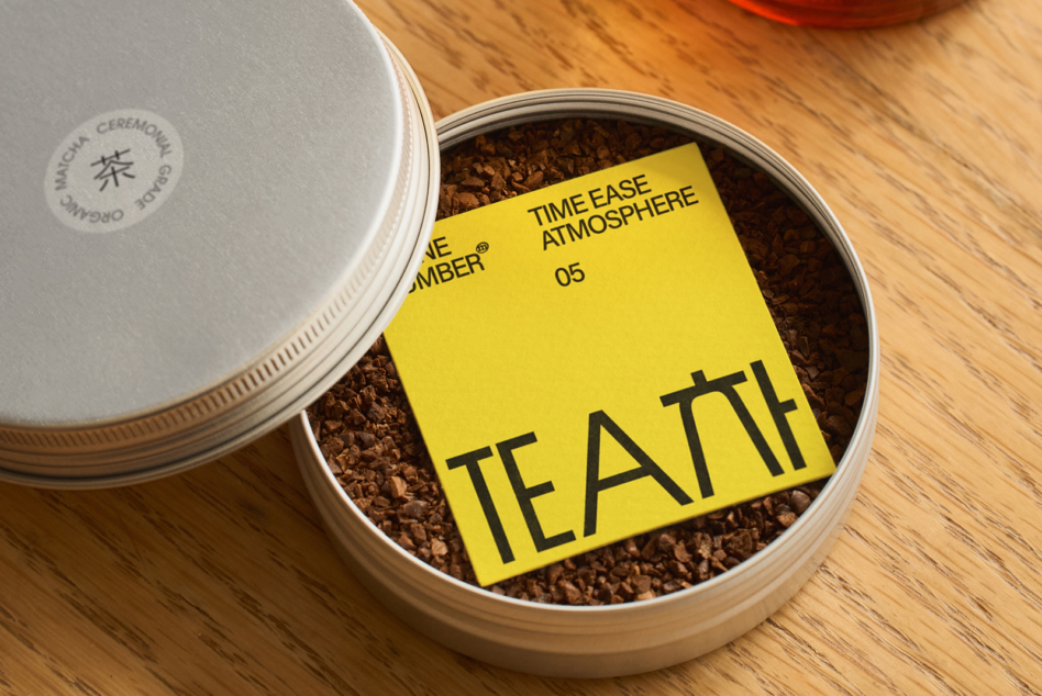 Yellow card label resting in loose tea inside white canister