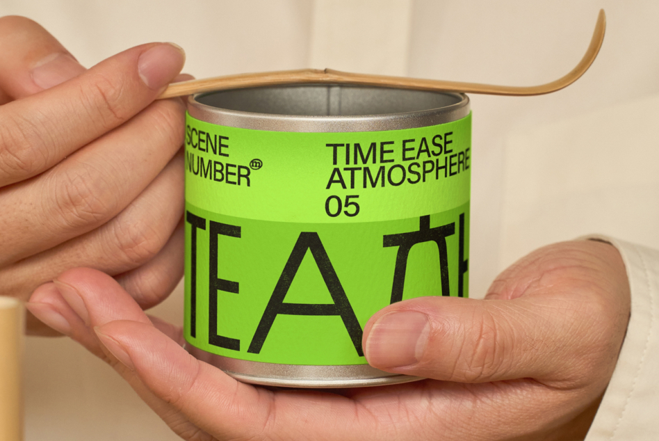 Hands gripping green tea canister with wooden lid holder