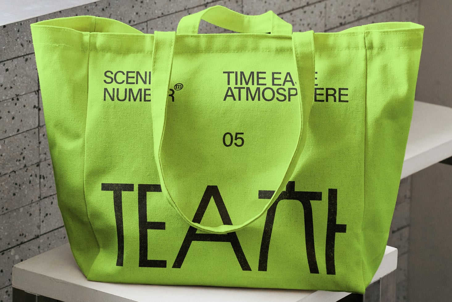 Bright green tote with large black TEA text, front view on white platform