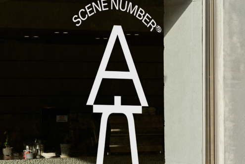 Large white neon letter A on black storefront with Scene Number branding