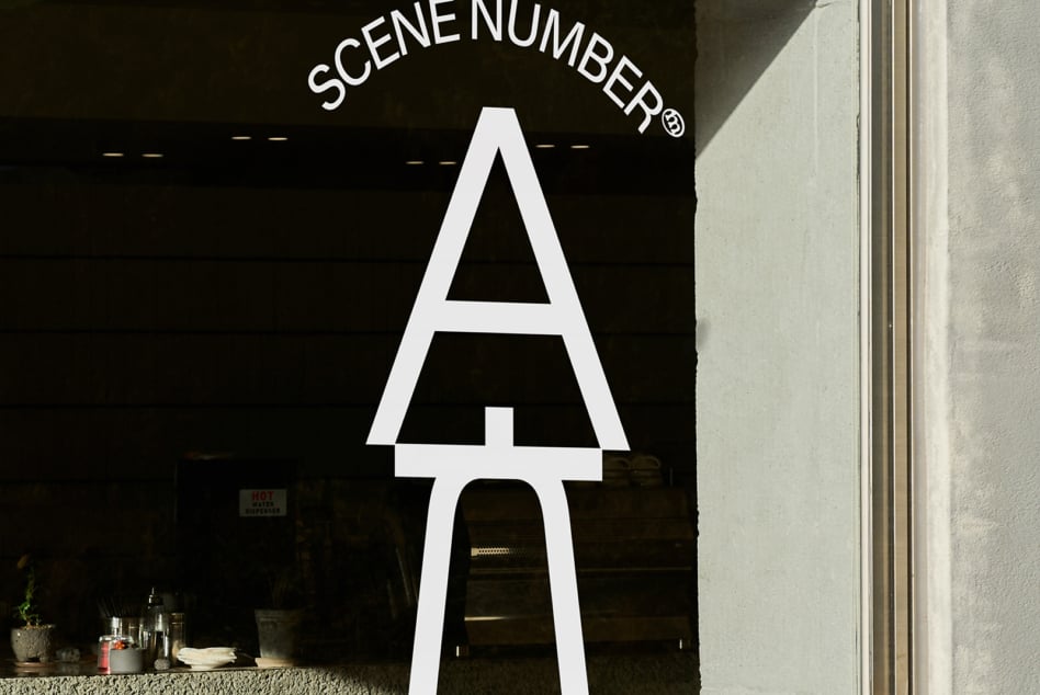 Large white neon letter A on black storefront with Scene Number branding