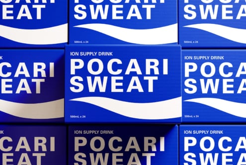 Pocari Sweat drink cans stacked showing blue label with white wave design detail