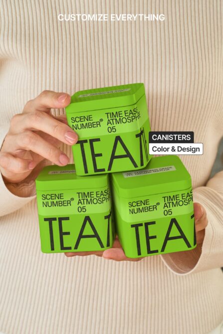 Bright green tea canisters with lime gradient held in hands