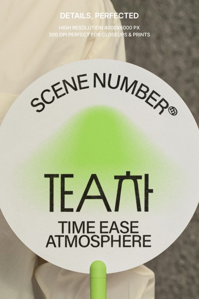 Close up of round white clapper board with green gradient circle in center