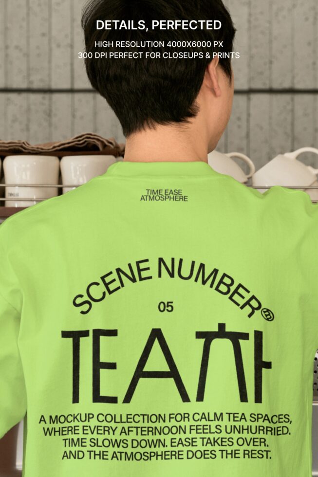 Guy in bright lime tee standing in calm tea space with crockery