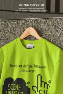 Neon lime crewneck tee on wooden hanger against concrete wall