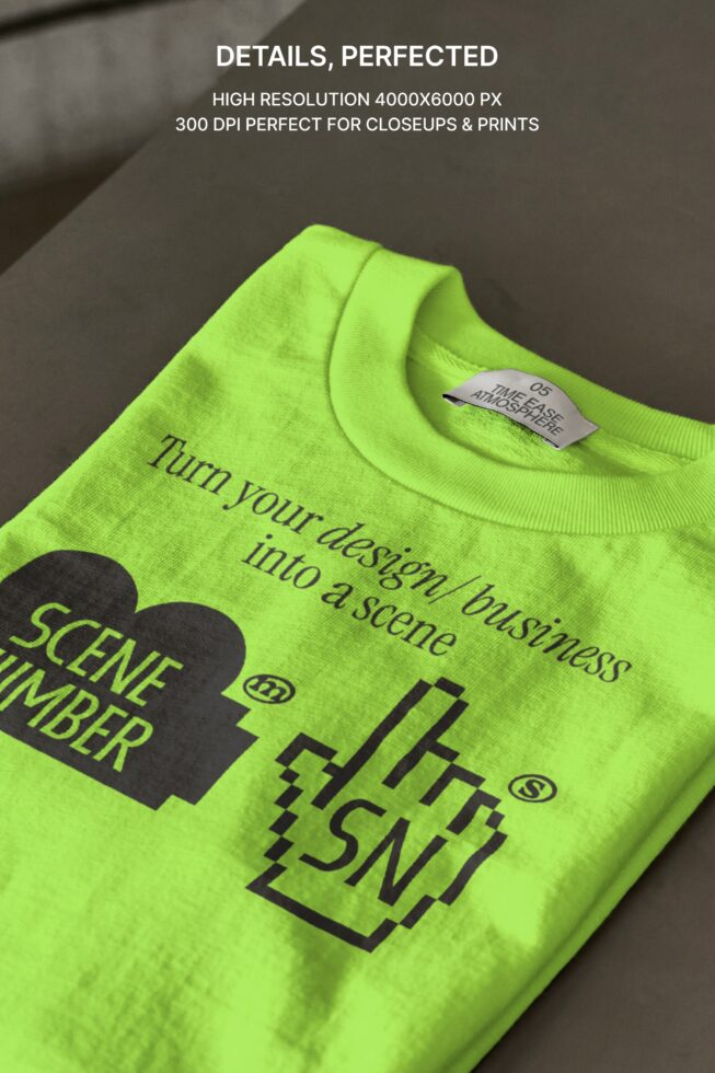 Neon yellow crewneck sweatshirt folded showing black printed design up close