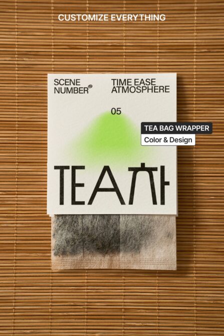 Tea bag wrapper mockup on wooden mat with fabric swatch below packaging