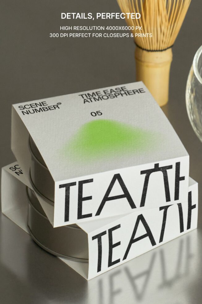 Stacked branded boxes with matcha whisk, bowl, spoon arranged on neutral surface