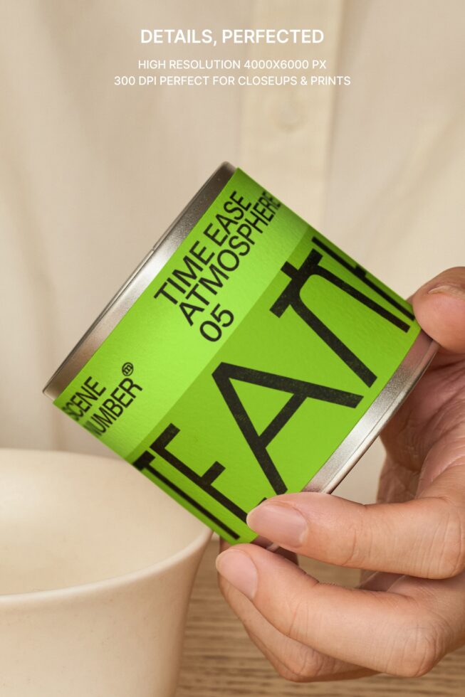 Close up of lime green tea tin label held in hands above ceramic cup setup