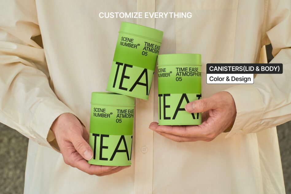 Hands holding three green canisters with white lids, TEA branding visible on each