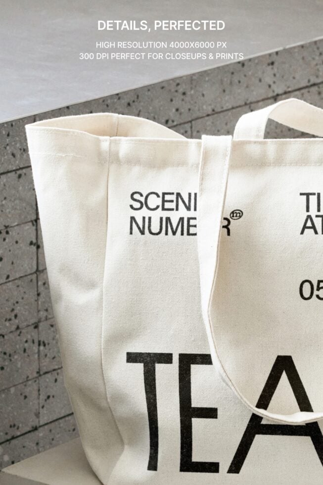 Overhead shot of white canvas tote bag detail on concrete background