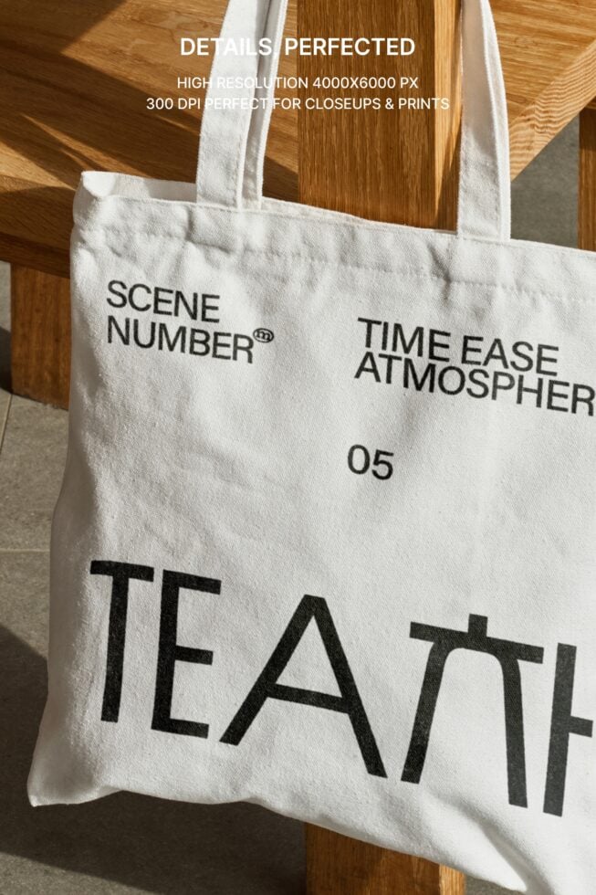 Close up of white tote bag hanging on wooden chair back showing details