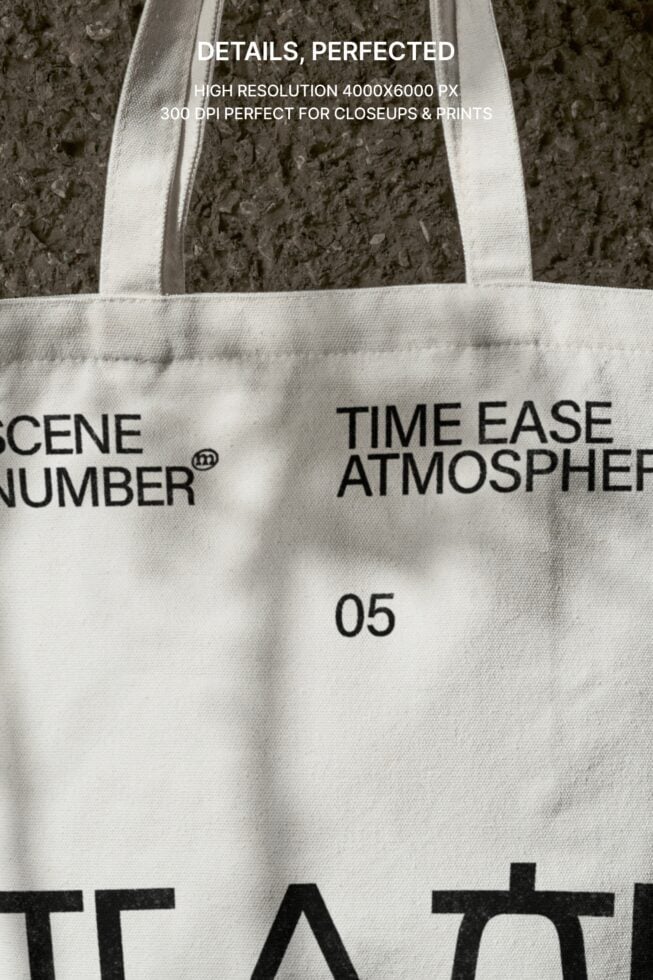 Overhead flat lay of cream tote showing printed design on concrete surface