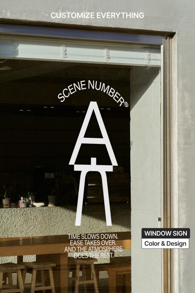 Storefront window with large white letter A blocking view of interior seating
