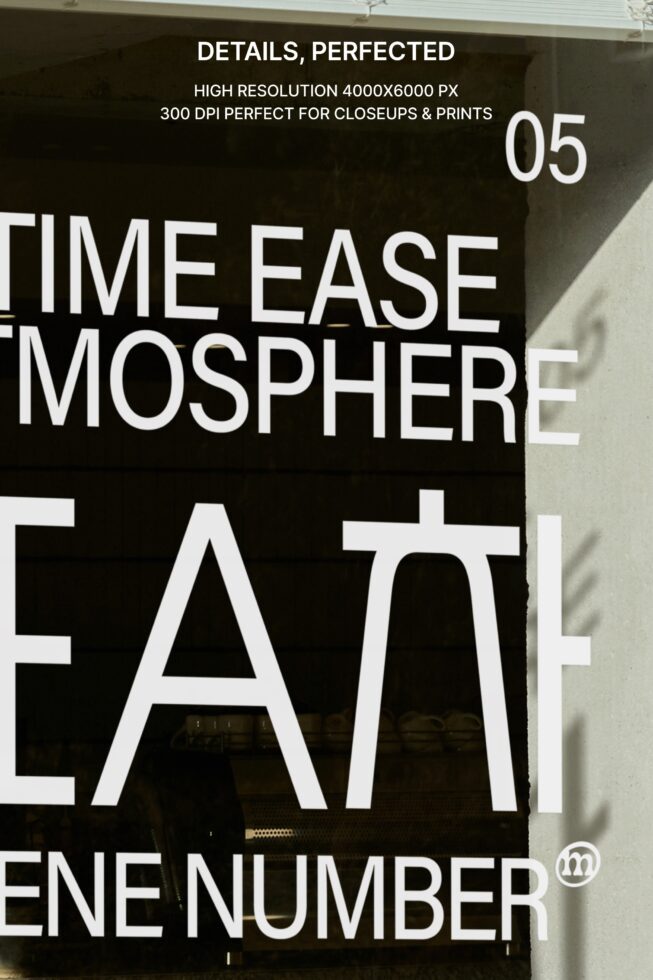 Close-up of black text on cream tote bag detail shot against textured wall
