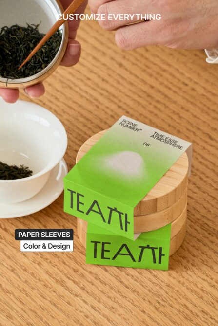 Green paper sleeve wrapped around wooden container with tea bowl in frame