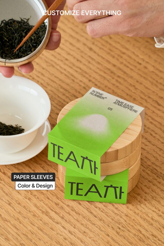 Green paper sleeve wrapped around wooden container with tea bowl in frame