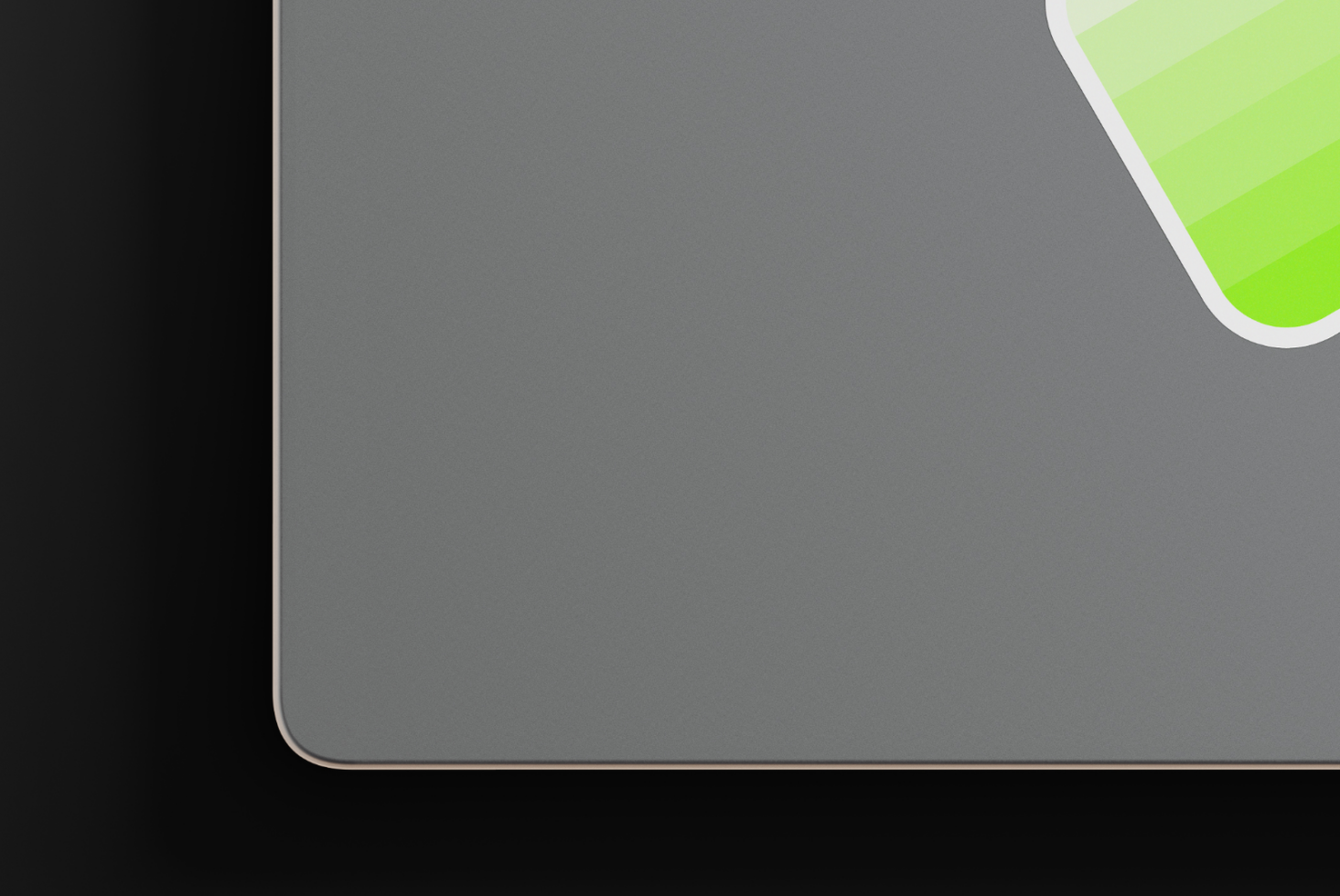 Close up of gray device corner with lime green accent curved element