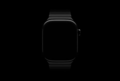 Black smartwatch with blank dark screen centered on black background