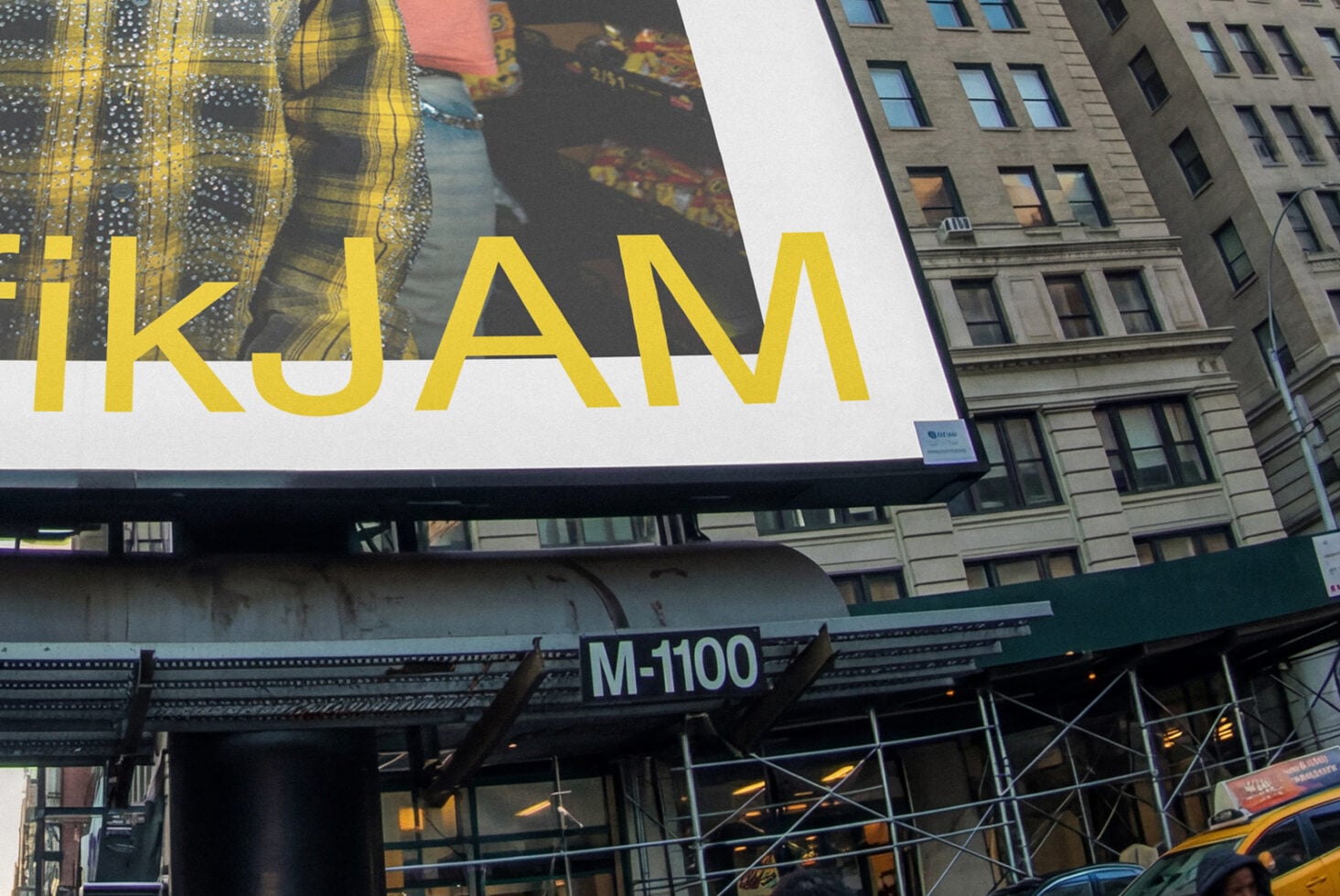 Street-level view of big billboard with yellow IKJAM text overlaid