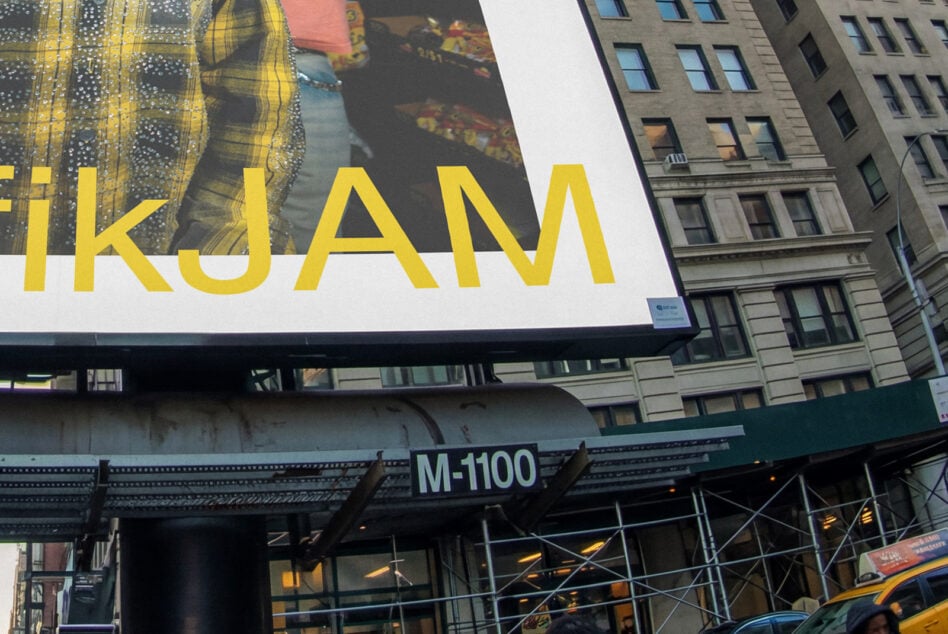 Street-level view of big billboard with yellow IKJAM text overlaid