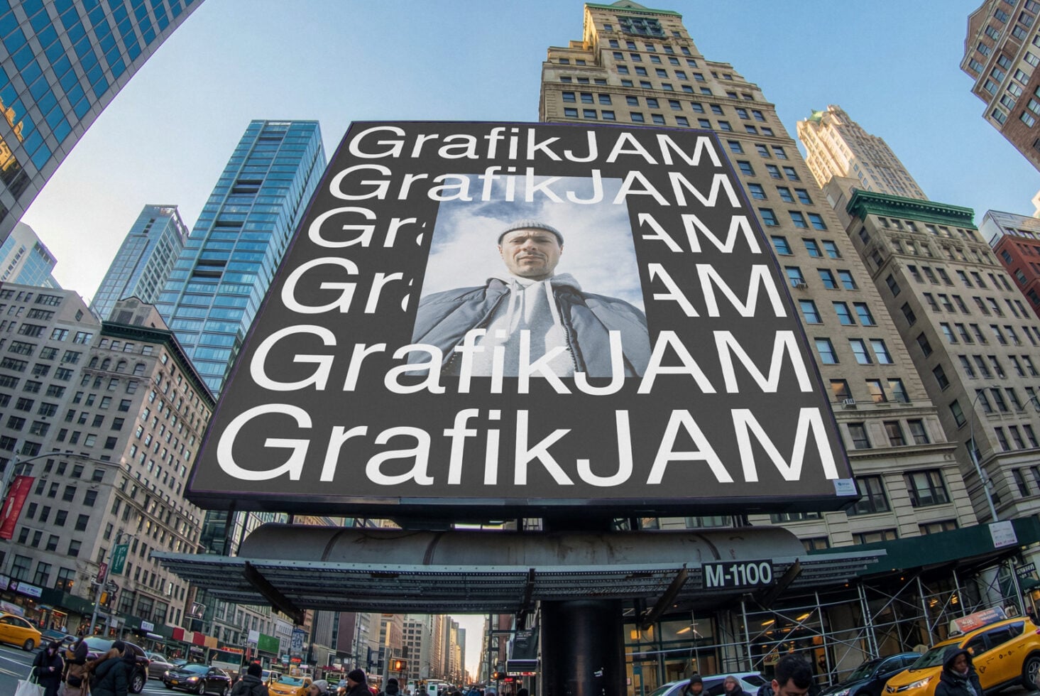 Large billboard showing repeating GrafikJAM text with portrait center