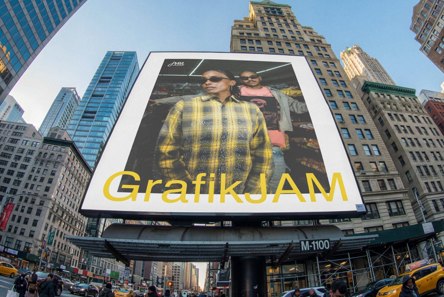 Oversized billboard featuring two people in yellow plaid with GrafikJAM text