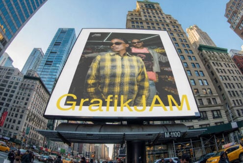 Oversized billboard featuring two people in yellow plaid with GrafikJAM text