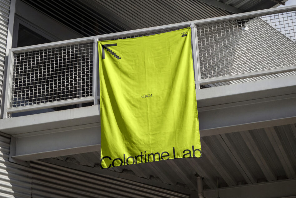 Bright neon yellow banner hanging on industrial railing in warehouse space