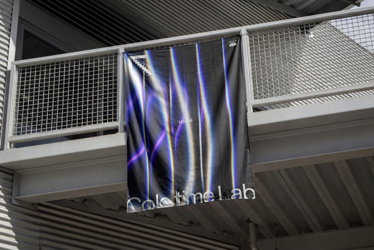Dark fabric banner with neon blue pink streaks hanging on metal railing