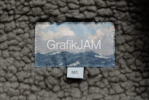 Mountain landscape printed on label with GrafikJAM text, dark textured background