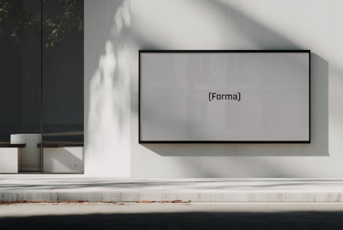 Blank wide monitor mockup on bright white wall with dramatic shadow