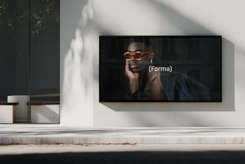 Ultra-wide display mockup showing man posing in statement orange sunglasses