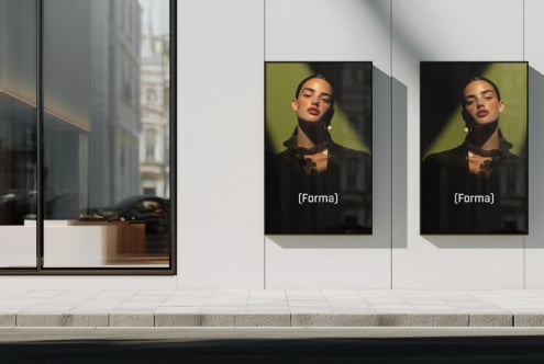 Two portrait photos of woman in black blazer displayed on storefront window with lime green backdrop