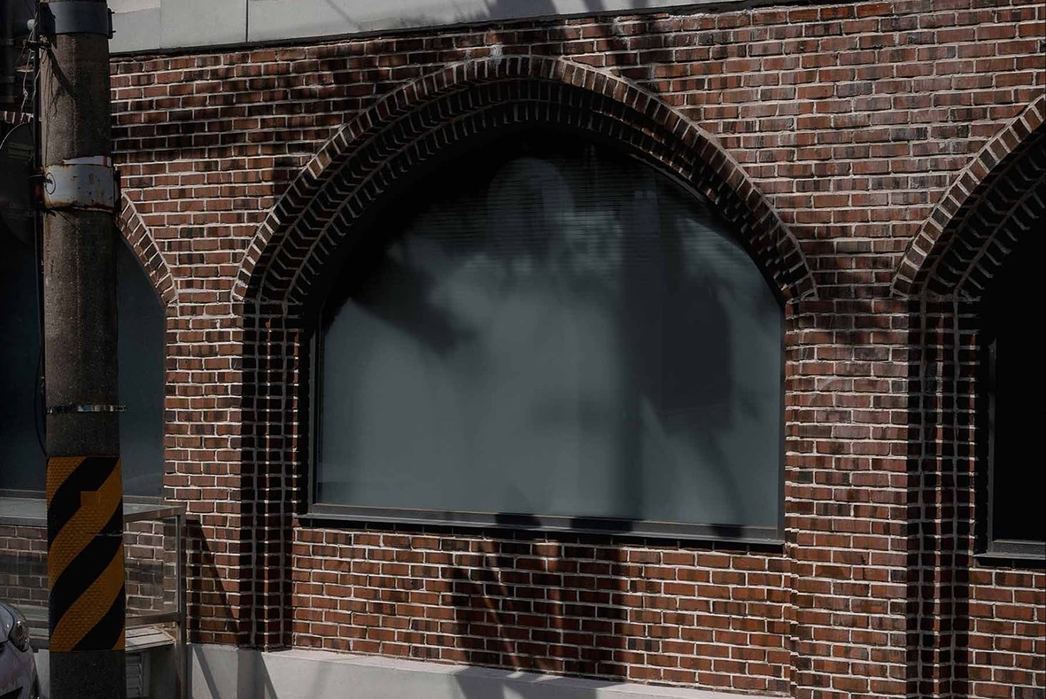 Close up of brick archway storefront window display blank