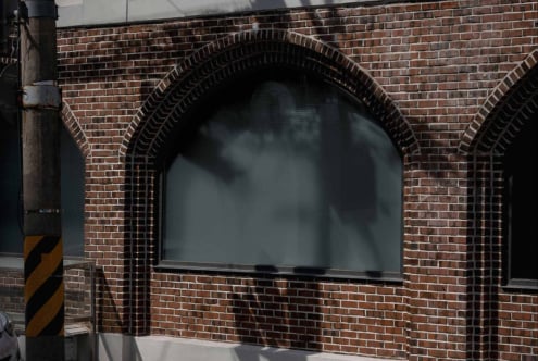Close up of brick archway storefront window display blank