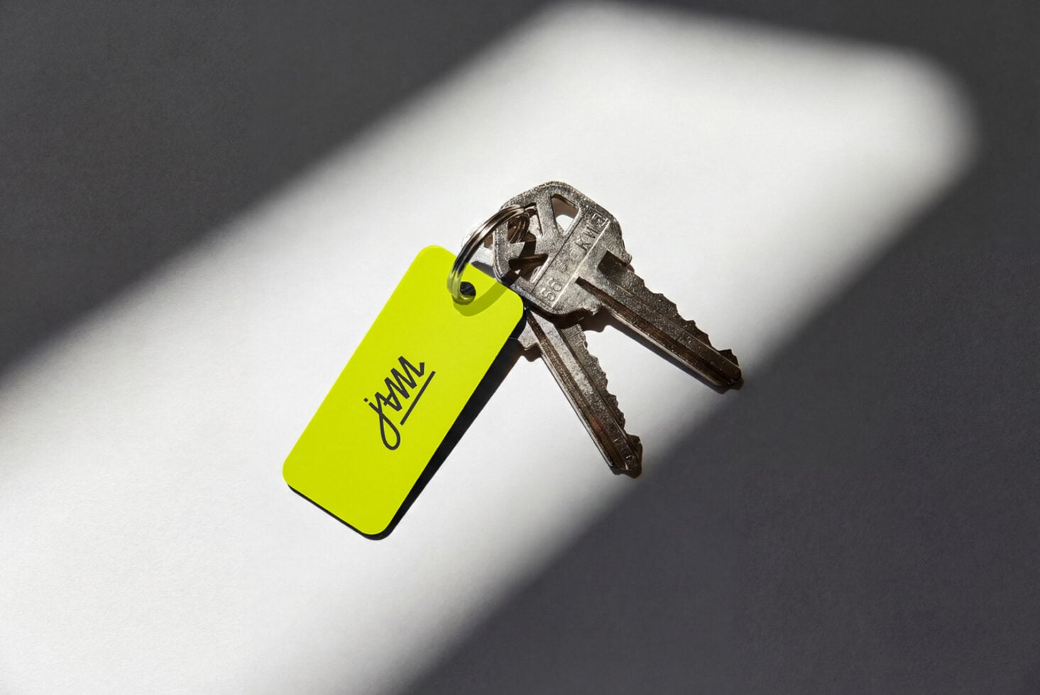 Neon yellow key tag with jWML handwritten logo on vintage metal keys
