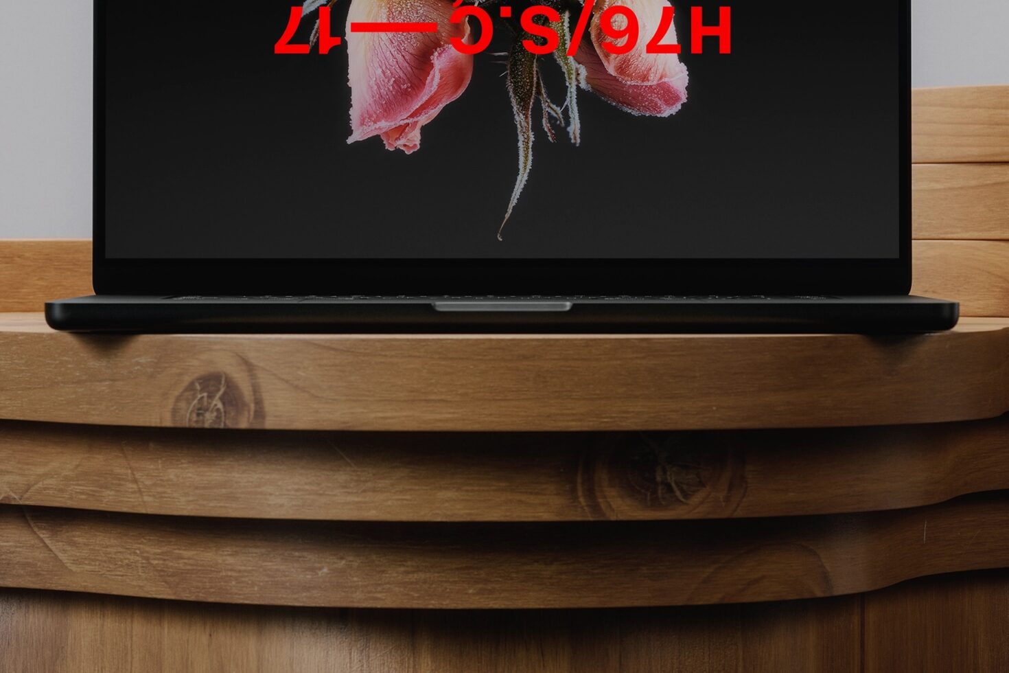 Laptop mockup on curved wood shelf showing pink roses with red text overlay