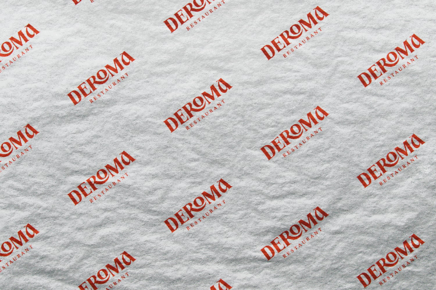 Deromo Restaurant logo stamped across white textured paper surface