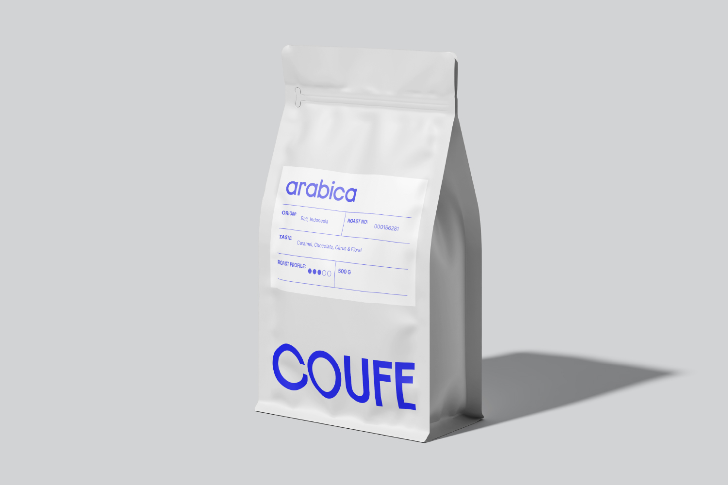 White coffee bag mockup with blue arabica label showing origin, taste, roast info