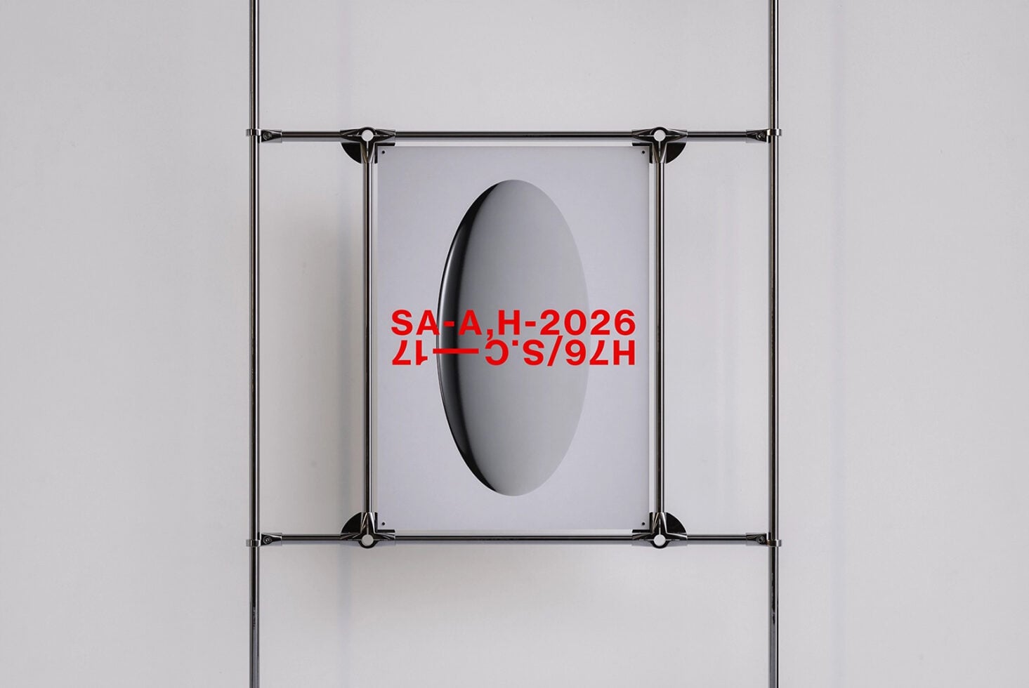 Metal clamp frame with oval cutout displaying red text on poster