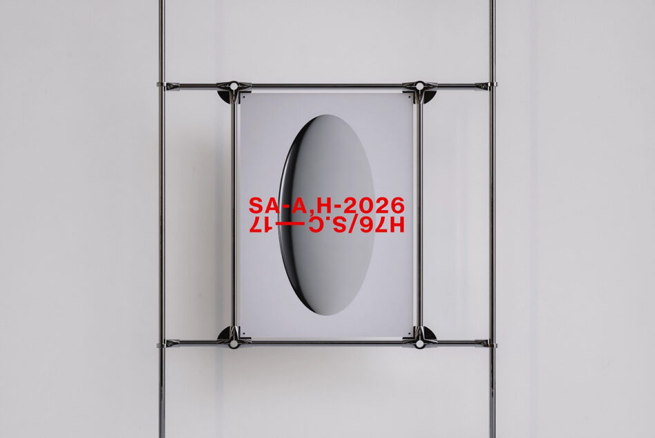 Metal clamp frame with oval cutout displaying red text on poster